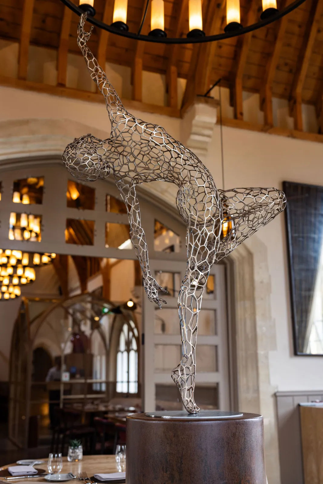 ‘Parallel Passé’ by Simon Gudgeon, a limited-edition figurative bronze sculpture inspired by Prima Ballerina Ksenia Ovsyanick. The life-size female dancer is captured en pointe in an elegant, dynamic ballet pose, formed through an intricate open Voronoi lattice that allows light and the surrounding environment to pass through and transform the sculpture.