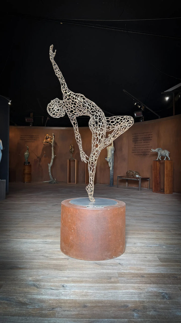 ‘Parallel Passé’ by Simon Gudgeon, a limited-edition figurative bronze sculpture inspired by Prima Ballerina Ksenia Ovsyanick. The life-size female dancer is captured en pointe in an elegant, dynamic ballet pose, formed through an intricate open Voronoi lattice that allows light and the surrounding environment to pass through and transform the sculpture.