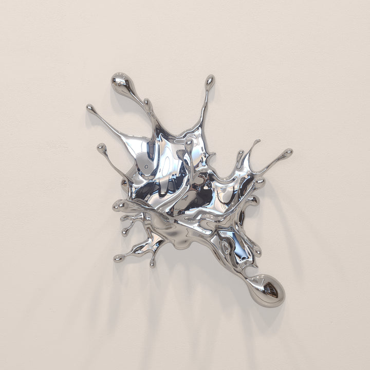 Wall-mounted stainless steel sculpture resembling a dynamic liquid splash frozen mid-motion, with high-shine chrome finish and flowing, organic extensions.