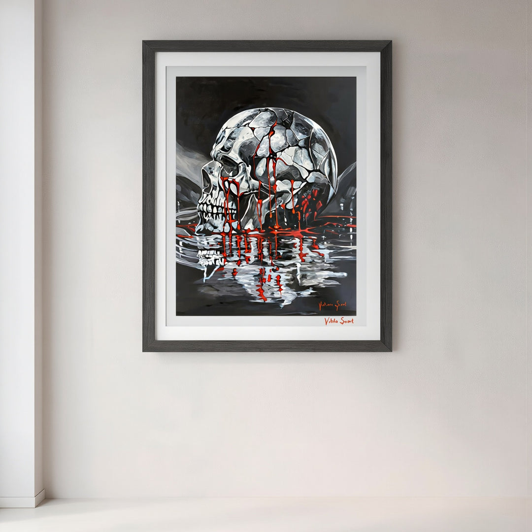 Victoria Saint Stillwater print of a fractured silver skull resting above dark reflective water, with soft red tones flowing into the surface, exploring themes of endurance, release and quiet reflection.