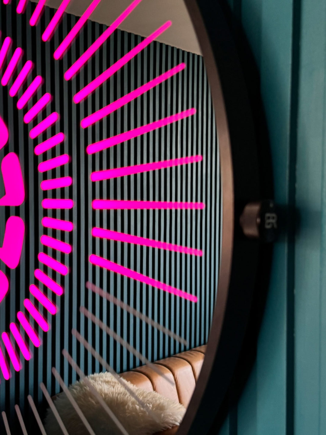 “Tempus Obsidian” by Ben Rousseau – a limited-edition illuminated wall timepiece crafted from grey mirrored glass and brass-tinted aluminium with LEDs. Inspired by obsidian, it radiates calm through subtle light and refined design.

