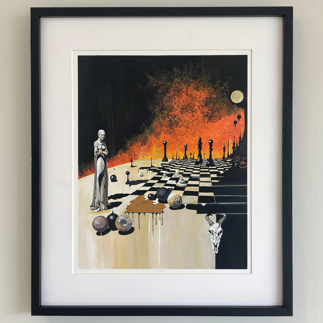 Victoria Saint Unmoved print of a calm, statuesque female figure beside a chessboard set against a dramatic burning landscape, symbolising control, foresight and stillness amidst chaos.